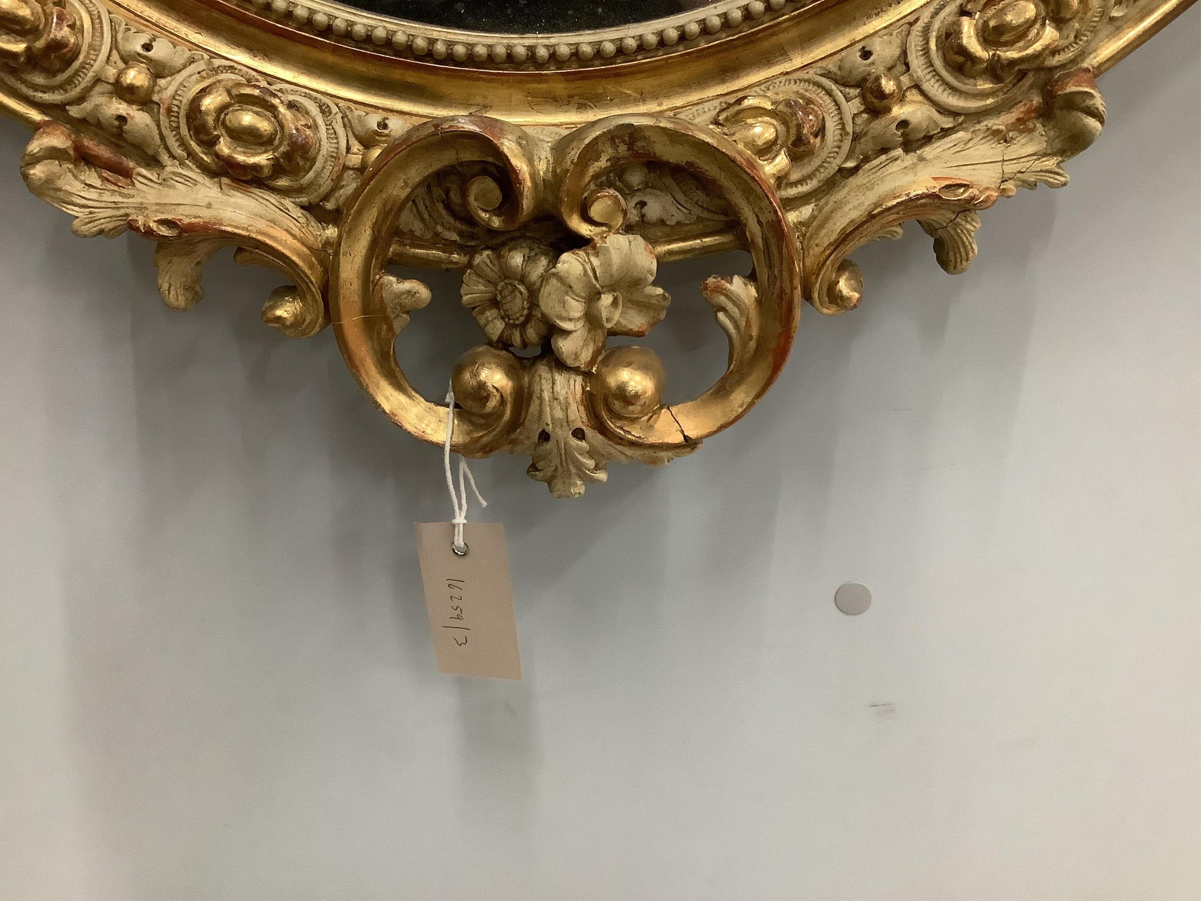 A 19th century French giltwood and gesso wall mirror, width 73cm, height 112cm. Condition - fair, some small losses to the upper crest